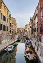 Motorboats and colourful house facades on a small canal, Venice, Veneto, Italy, Europe