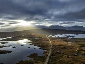 Morning light, cloudy mood, sunbeams, loch, moor, mountain landscape, aerial view, road, autumn,