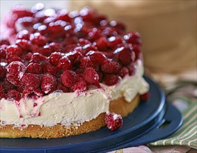 A fresh, creamy raspberry tart with fresh raspberries and cream