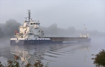 Cargo ship Friedhelm sailing in fog in the Kiel Canal, Kiel Canal, Schleswig-Holstein, Germany,