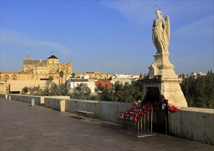 Angel San Rafael statue on Roman bridge with views cathedral, Cordoba, Spain, Europe