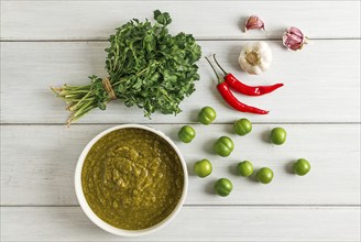 Tkemali sauce, traditional Georgian cuisine, green cherry plum, with ingredients for sauce,