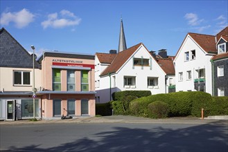 Hattingen Old Town Clinic and residential building with the leaning tower of St George's Church in