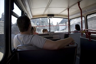 Passengers inside top deck of double decker bus