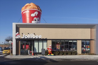 Sterling Heights, Michigan, Workers serve up Chickenjoy fried chicken at Jollibee, a Filipino fast