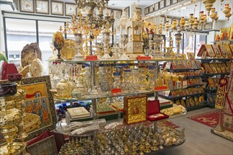 Interior of a shop full of religious artefacts with icons and candlesticks, Ouranoupoli, City of