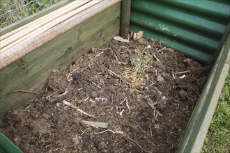 Rotted compost in garden composting bin