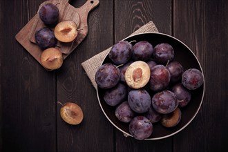 Blue plum, on a wooden table, top view, close-up, no people