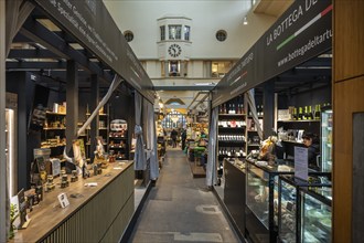 Various market stalls with delicatessen products from different nations in the historic market hall