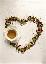 Tea set, heart-shaped, with a cup, top view, on a white background, rosebuds, jasmine, blue,