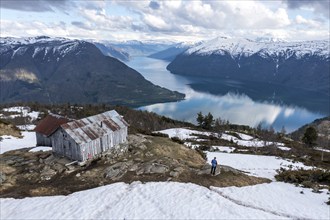 Hiker looking over the Sognefjord, half way up to Mt. Molden, Norway, Europe