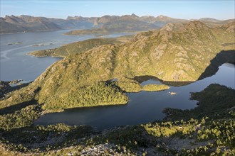 Aerial view of mountains and lake near Mt. Sukkertoppen, the mountain next to Hamn i Senja, Senaj