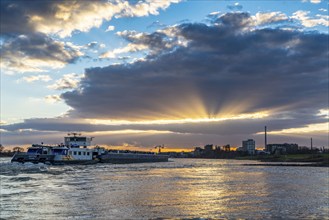 Cargo ship on the Rhine between Duisburg and Krefeld, dramatic sunset, North Rhine-Westphalia,