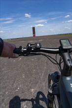 Cycling in the Ruhr area, on the Schurenbach slag heap, Bramme landmark for the Ruhr area by artist