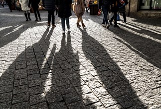 Pedestrians in a pedestrian zone, winter, long shadows, Dortmund, North Rhine-Westphalia, Germany,