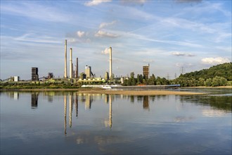 Industrial backdrop of the ThyssenKrupp Steel steelworks in Bruckhausen, on the Rhine, cargo ship,