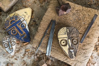 Wooden masks in a workshop, carving, carving, art, artist, sculpture, symbol, face, comic, culture,