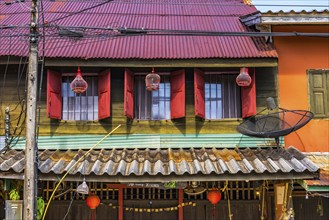 Facade with lampinons in the old town of Ko Lanta, dilapidated, house, colour design, window, row