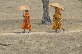 Novice and monk with parasol, Cambodia, Asia