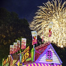 Cranger Kirmes with colourful ice cream stall and fireworks at night, Herne, Ruhr area, North