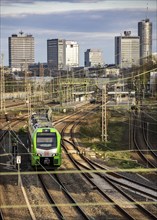 Train on the tracks west of Essen main station, skyline of the city centre, S-Bahn train, North