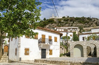 Village houses and hilltop Greek Orthodox church of Saint Mary, or Panagia Monastery, Dhermi,