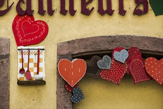 Facade of a restaurant with a heart in the old town centre, Colmar, Alsace, Bas-Rhin, France,