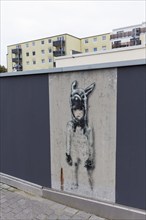 Little girl with animal cap, only surviving mural on a freshly painted wall, by street artist L.E