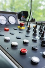 Close-up of an industrial control panel with various buttons, Hermann Hesse railway track