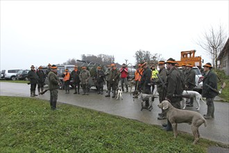 Hunting guide giving a speech to hunters and beaters in front of the start of the hunt for brown