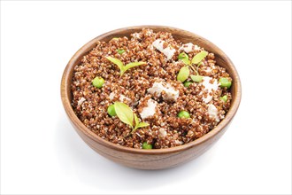 Quinoa porridge with green pea and chicken in wooden bowl isolated on a white background. Side