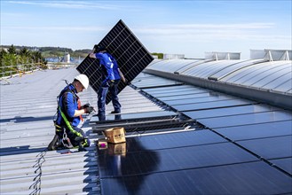 Installation of solar modules on the roof of a commercial enterprise, over 400 photovoltaic modules