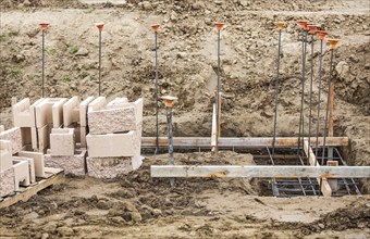 Rebar lining a cinder block wall construction site