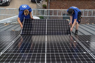 Installation of solar modules on the roof of a barn on a farm, over 240 photovoltaic modules are