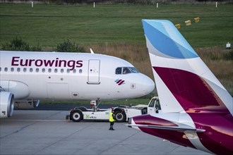 Eurowings aircraft on the apron, being cleared for take-off and pushed from the terminal,