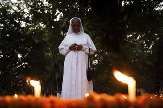 A Nun offer prayers on the grave during the All souls day observation, in Guwahati, India on 2