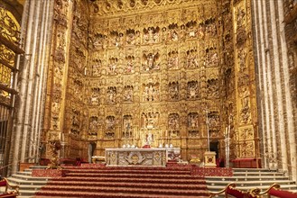 Gilded, ornately decorated altar in a cathedral, Seville