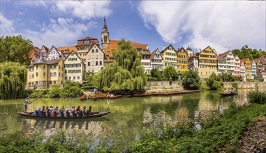 Neckarfront Tübingen with punt on the Neckar. Postcard motif with historic buildings, collegiate