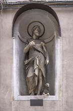 Sculpture of Juesu with the lamb, in a niche on the façade of a residential building, Genoa, Italy,