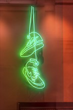 Trainers as illuminated advertising in a sports shop, Genoa, Italy, Europe