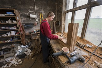 Young man builds a table in his workshop, Mecklenburg-Vorpommern, Germany, Europe