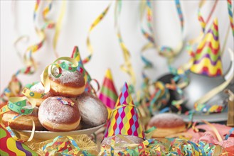 Carnival atmosphere with party hats and doughnuts on a table