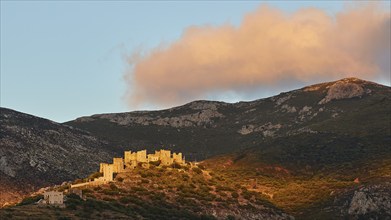 Majestic historic buildings illuminated by the last evening sun on a hilltop, Vathia, residential