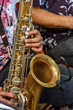 Saxophonist and group of musicians during a musical performance on the streets of Recife, Recife,