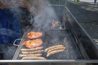 Roast sausages and pork steak on a charcoal grill, Kirchweih in Franconia, Bavaria, Germany, Europe