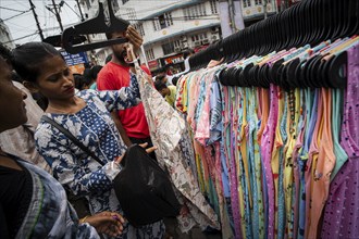 People buys clothes at a street market ahead of Durga Puja festival on October 7, 2024 in Guwahati,