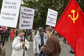 Demonstrators hold placards with slogans such as Stop war against Russia, Get out of Nato, Nato is