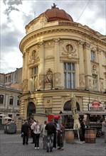 Bucharest, city centre, building in the old town and in front of it a sausage stand, Romania,