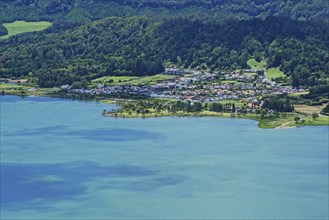 View of the picturesque small town of Sete Cidades on the blue crater lake Lagoa Azul embedded in a