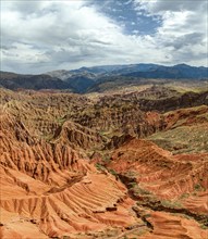 Eroded mountain landscape, canyon with red and orange rock formations, aerial view, Konorchek